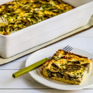 Square featured image for Mushroom and Feta Breakfast Casserole showing one serving in front and casserole dish in back.