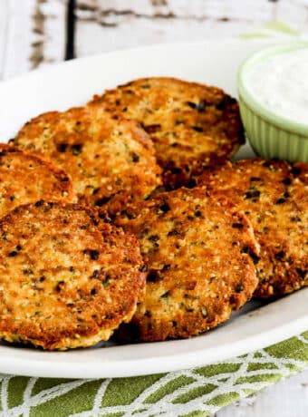 Square image of Salmon Patties with Tartar Sauce shown on serving platter.