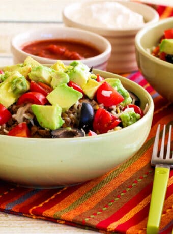 Square image of Spaghetti Squash Taco Bowl shown in two serving bowls with toppings.