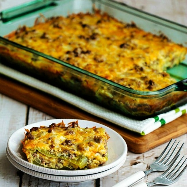 Beefy Cheesy Green Chile Bake casserole in baking dish and one serving on plate.
