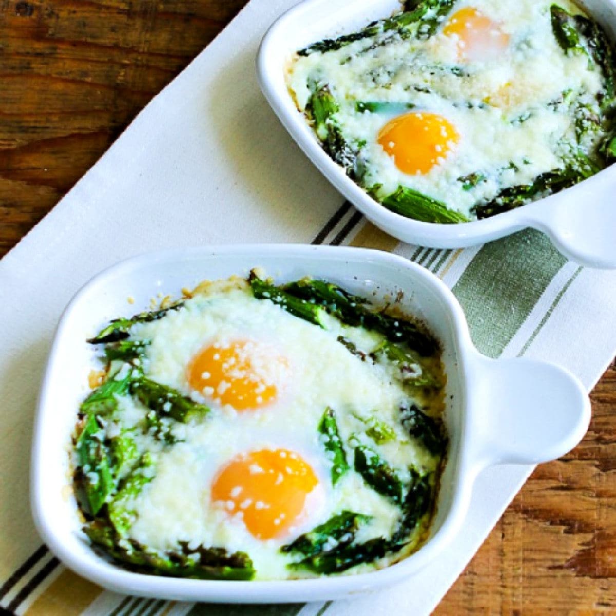 Square image for Baked Eggs and Asparagus with Parmesan shown in two gratin dishes.