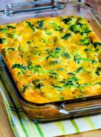 Square image for Broccoli Cheese Breakfast Casserole shown in baking dish on napkin and cutting board.