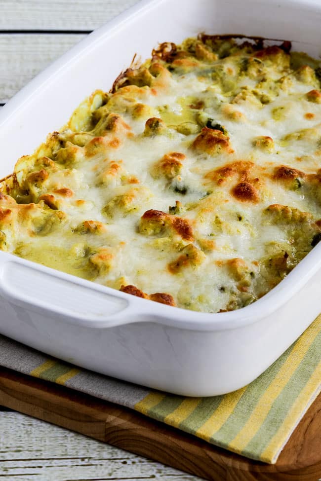 Chicken and Asparagus Bake with Creamy Curry Sauce shown in baking dish on cutting board.