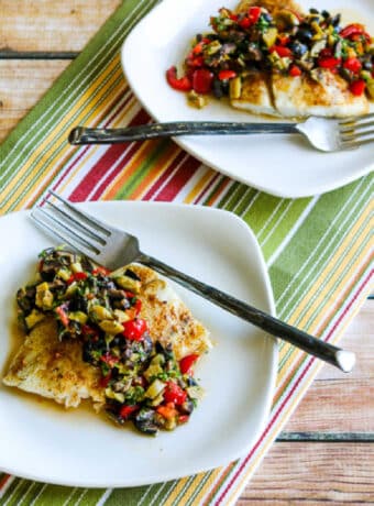 Roasted Barramundi with Tomato and Olive Relish with fish shown on two serving plates