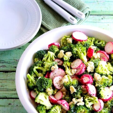 Broccoli and Radish Salad with Gorgonzola finished salad in serving bowl with plates and forks in background