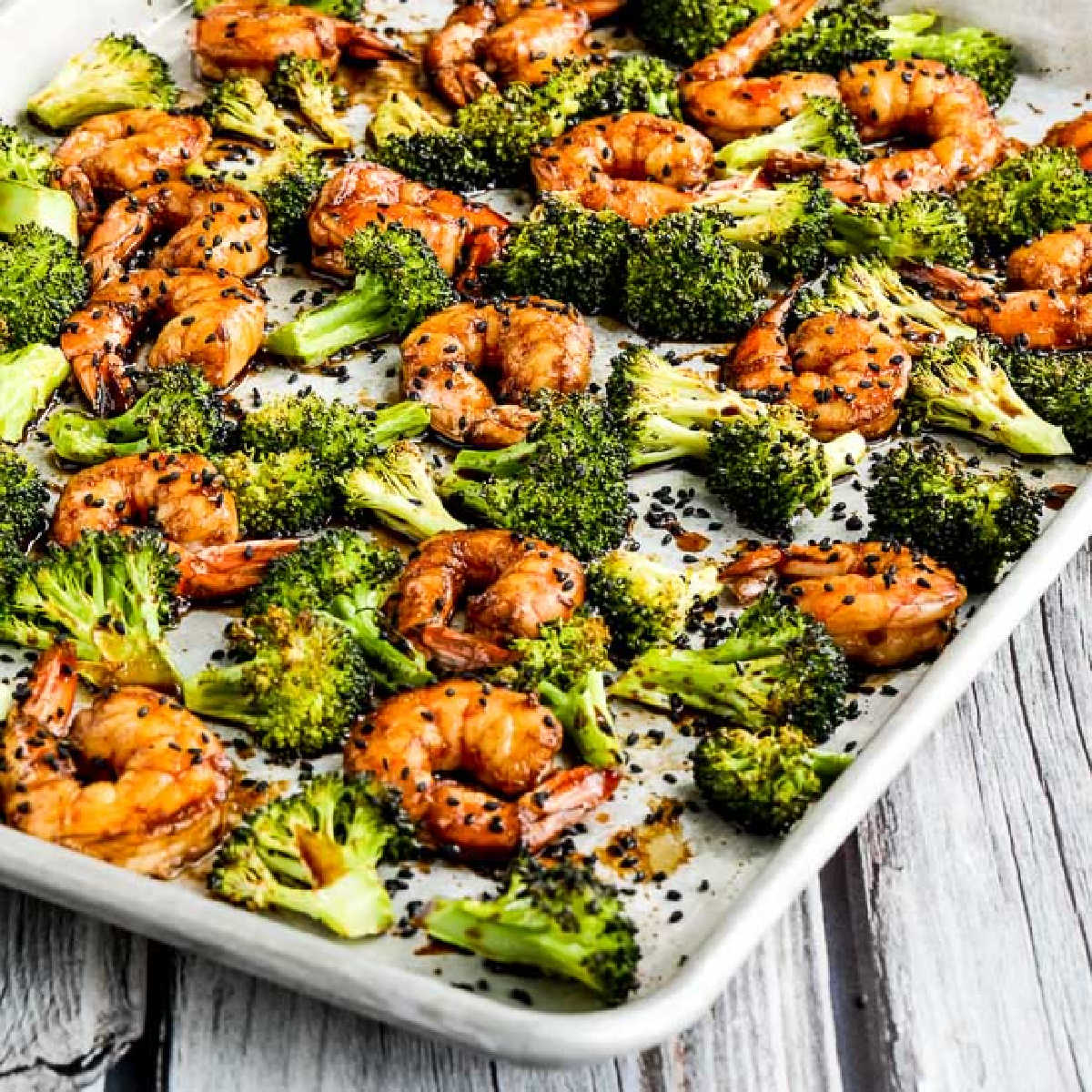 Square image of Shrimp and Broccoli Sheet Pan Meal shown on baking sheet.