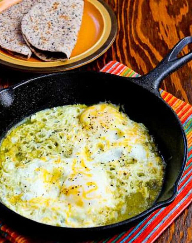 Fifteen Minute Salsa Verde Eggs cropped image with eggs in cast iron skillet and tortillas in back
