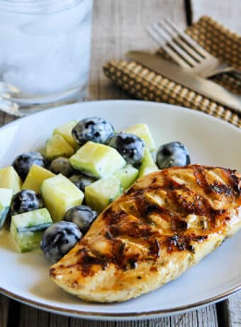 Grilled Chicken with Lemon and Capers square image of chicken on plate with cucumber olive salad