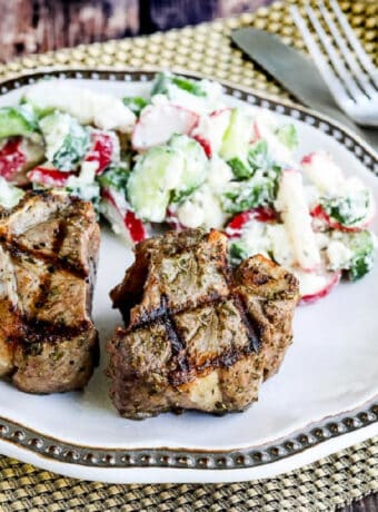 Square image for Grilled Lamb Chops with Garlic and Herbs, shown on plate with salad.