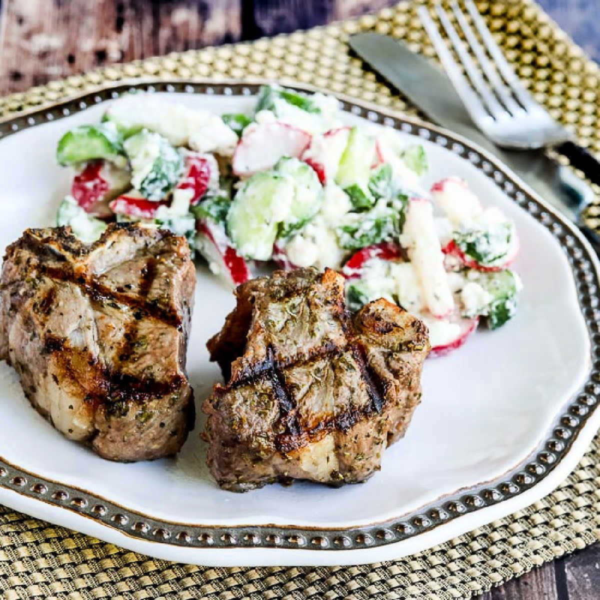 Square image for Grilled Lamb Chops with Garlic and Herbs, shown on plate with salad.