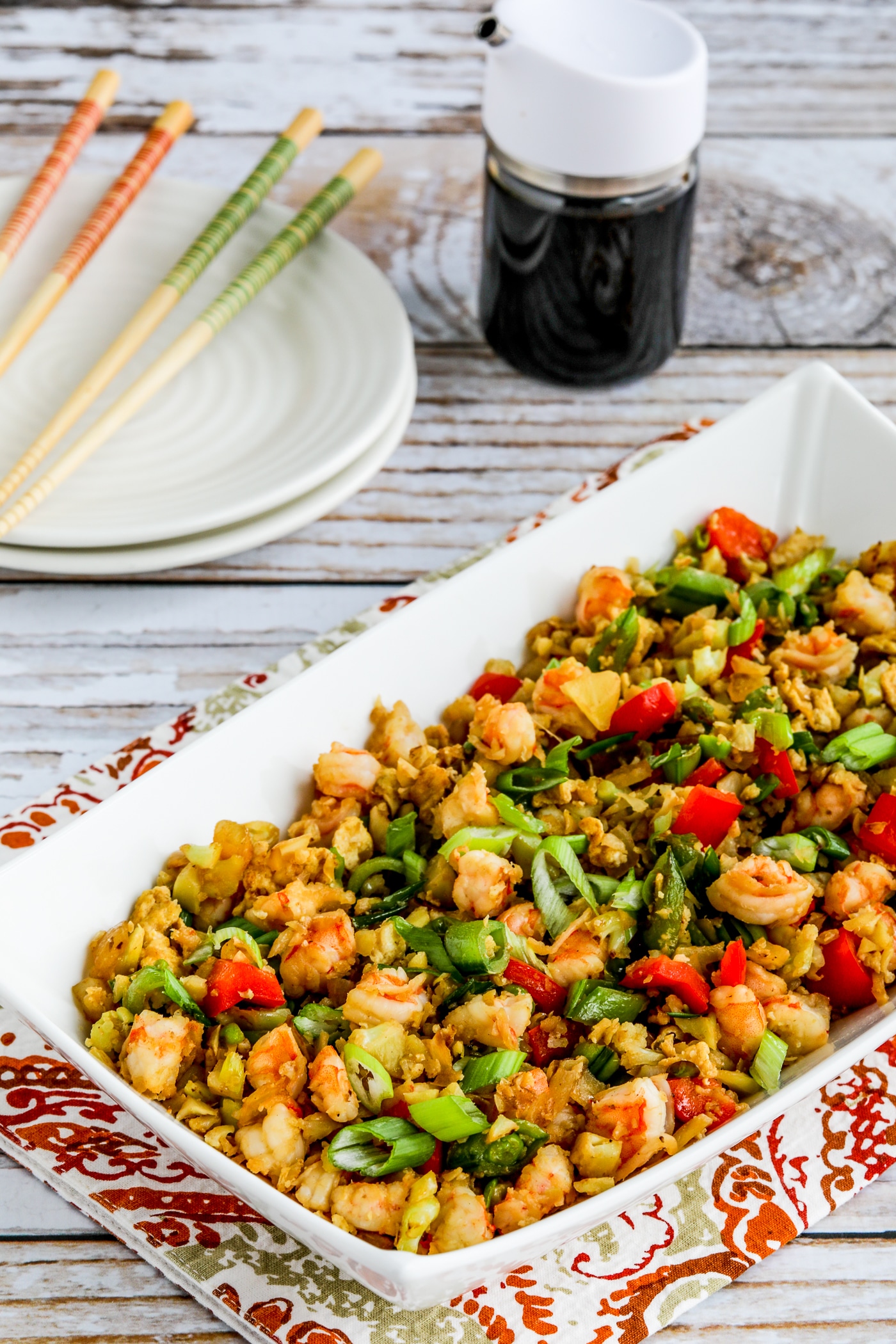 Cauliflower fried rice with a close-up of shrimp for fried rice in a serving bowl