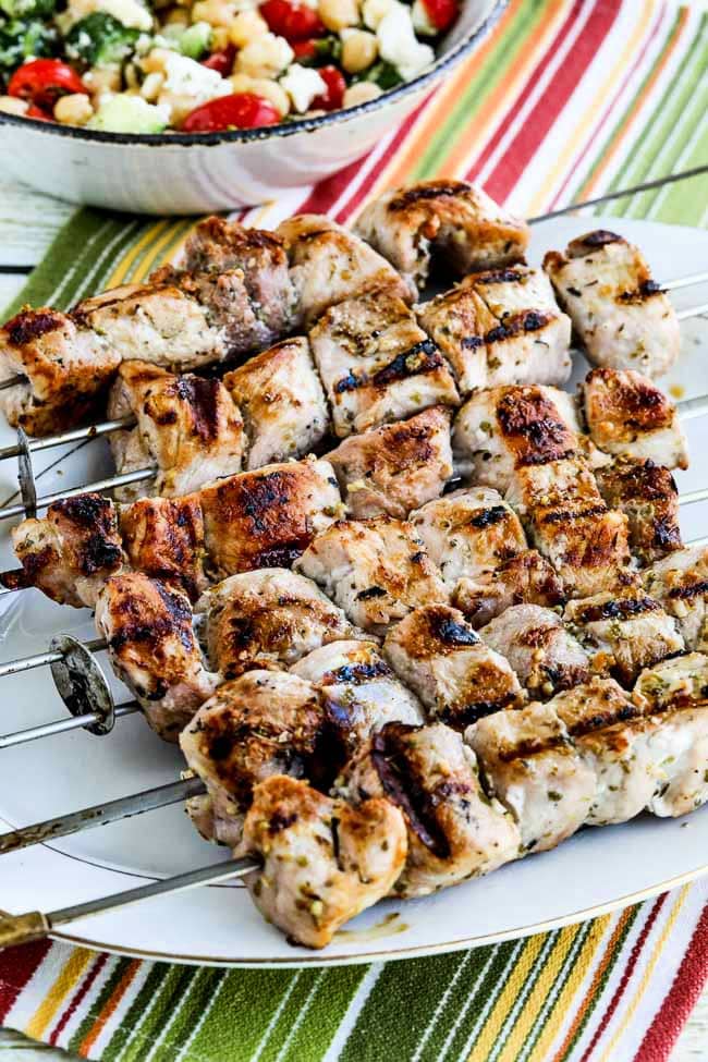 Kalyn's Pork Souvlaki Recipe shown on serving platter with salad in back.