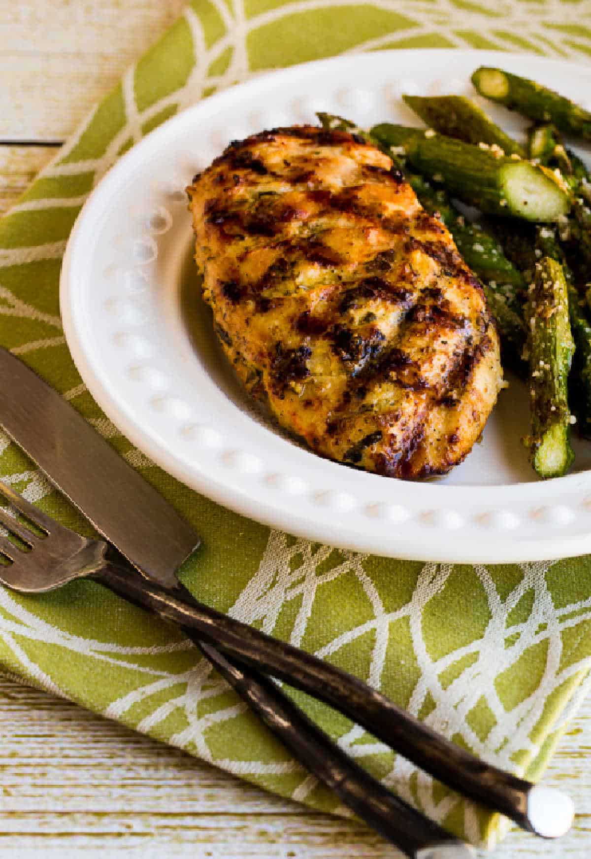 Rosemary Mustard Grilled Chicken on serving plate with asparagus