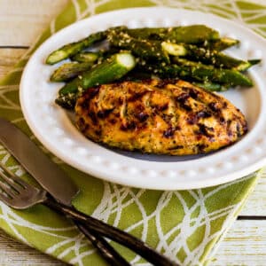 square image of Rosemary Mustard Grilled Chicken on serving plate with asparagus