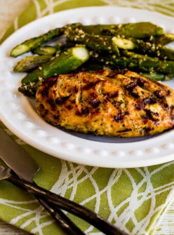 square image of Rosemary Mustard Grilled Chicken on serving plate with asparagus