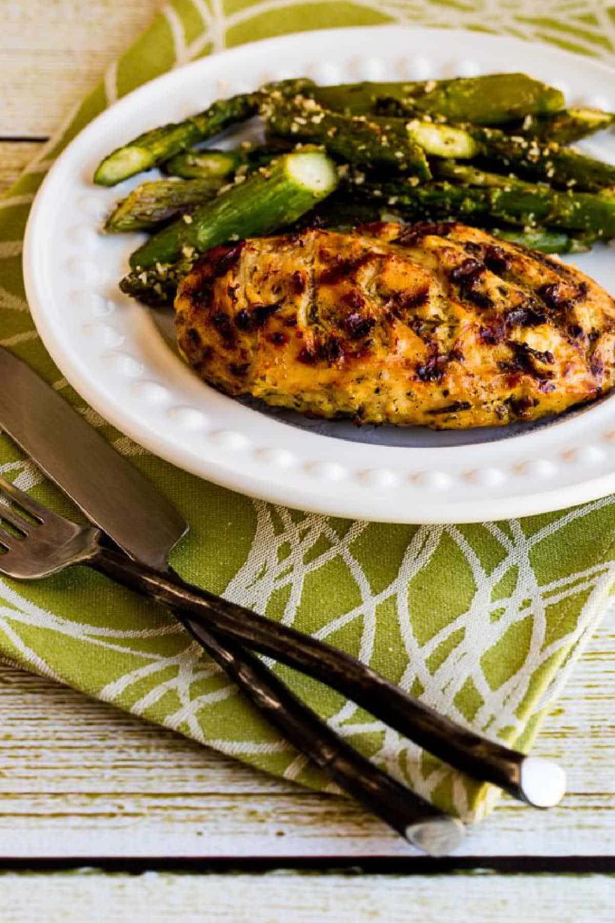 Rosemary Mustard Grilled Chicken on serving plate with napkin and fork/knife on the side