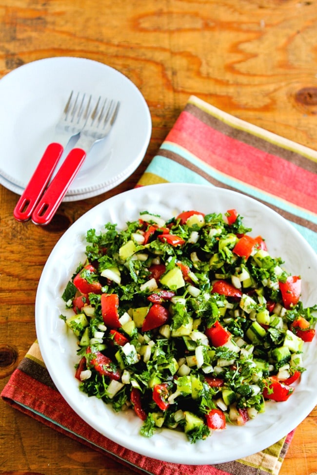 Middle Eastern Tomato Salad photo of salad in bowl with salad plates