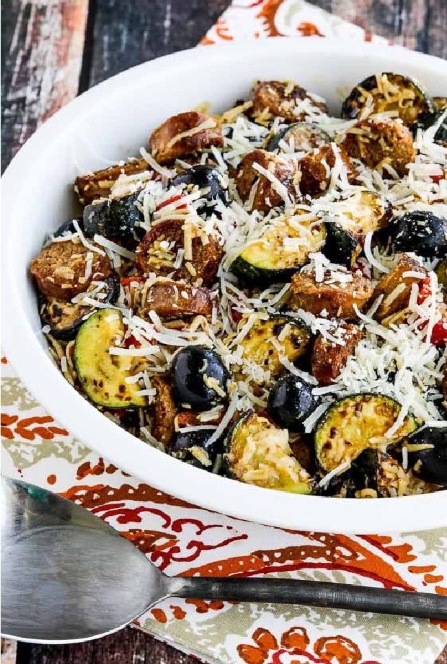 No-Pasta Salad with Zucchini and Italian Sausage shown in serving bowl with napkin and serving spoon