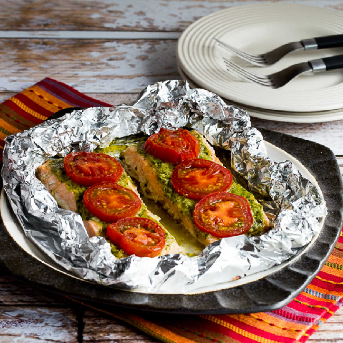 square image of Baked Salmon with Pesto and Tomatoes