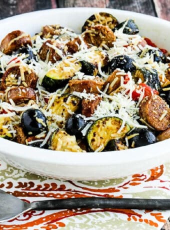 Square image of No-Pasta Salad with Zucchini and Italian Sausage shown in serving bowl.