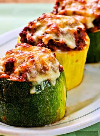 Meat, Tomato, and Mozzarella Stuffed Zucchini Cups shown on serving platter.