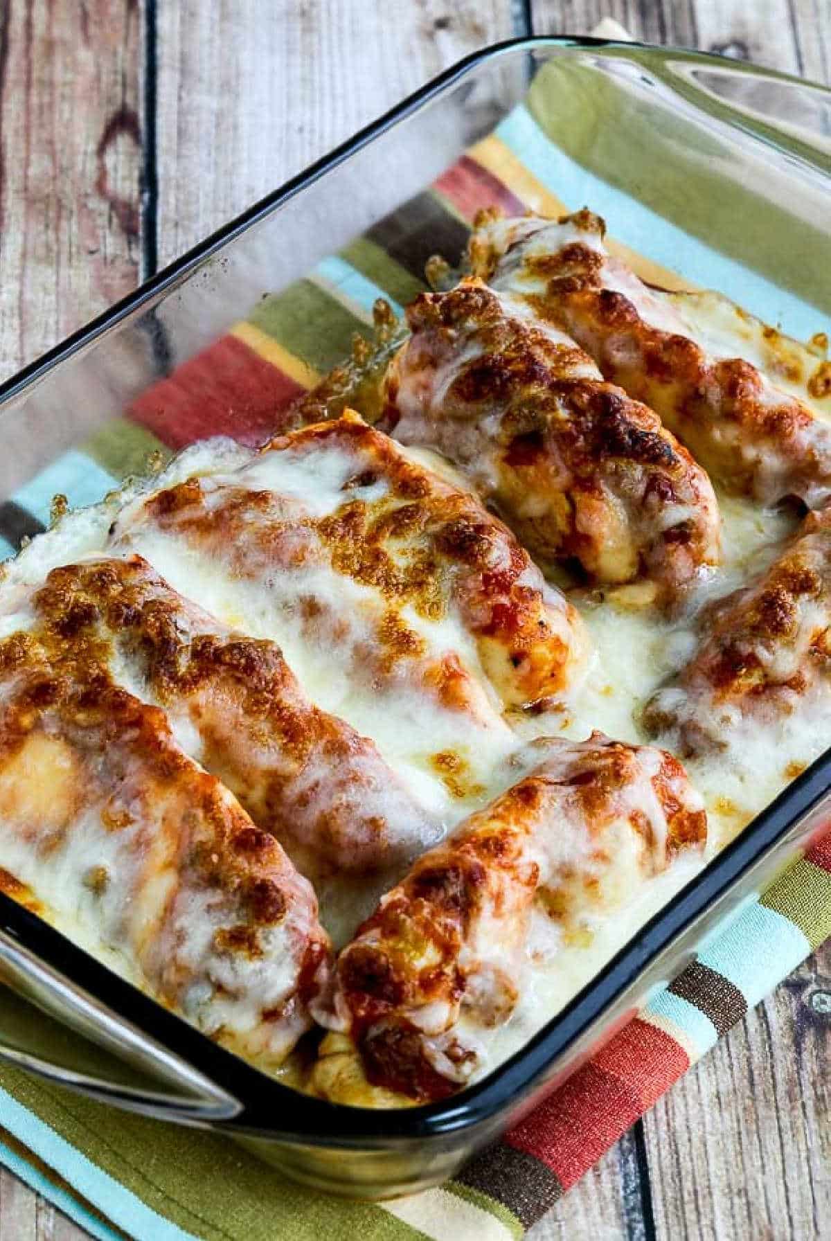 Instant Pot Salsa Chicken shown in baking dish with melted cheese