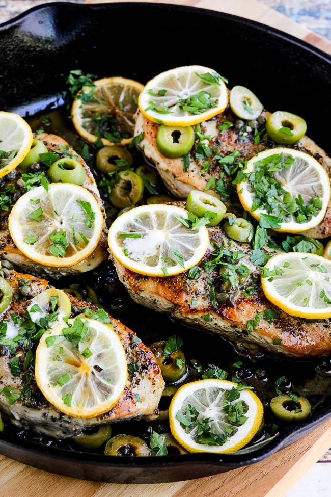 Skillet Chicken with Lemon, Green Olives, and Capers finished dish in skillet