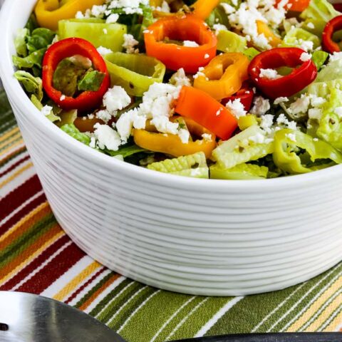 Peperoncini Chopped Salad with Romaine, Peppers, and Feta shown in salad bowl with serving spoon
