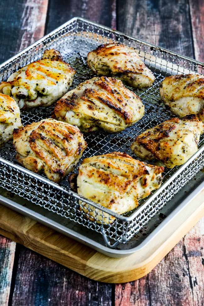 Herb-Marinated Air Fryer Chicken Thighs shown in air fryer basket