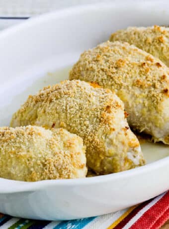 square image of Baked Stuffed Chicken Breast with Green Chiles and Cheese shown in baking dish