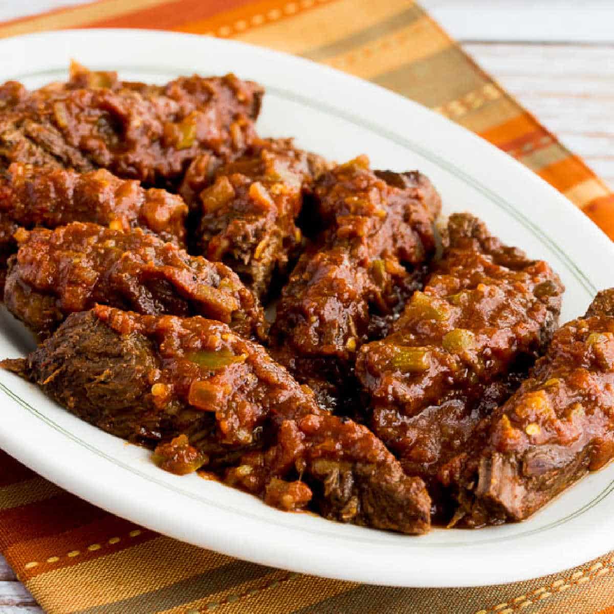 Southwestern Pot Roast shown on serving plate on colorful napkin.