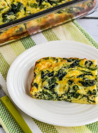 Spinach and Mozzarella Egg Bake square thumbnail image with one slice on plate and egg bake in casserole dish in the background