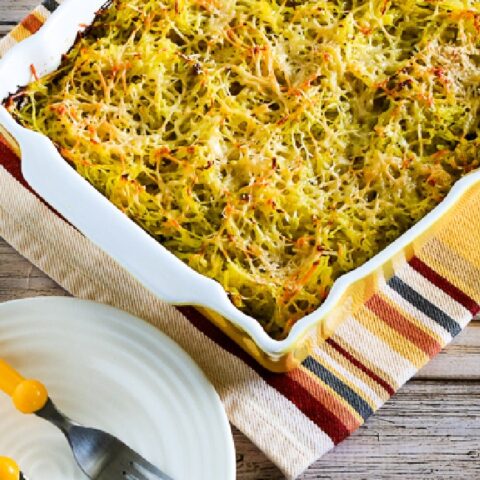 Twice-Baked Spaghetti Squash with Pesto in baking sheet with plates and forks