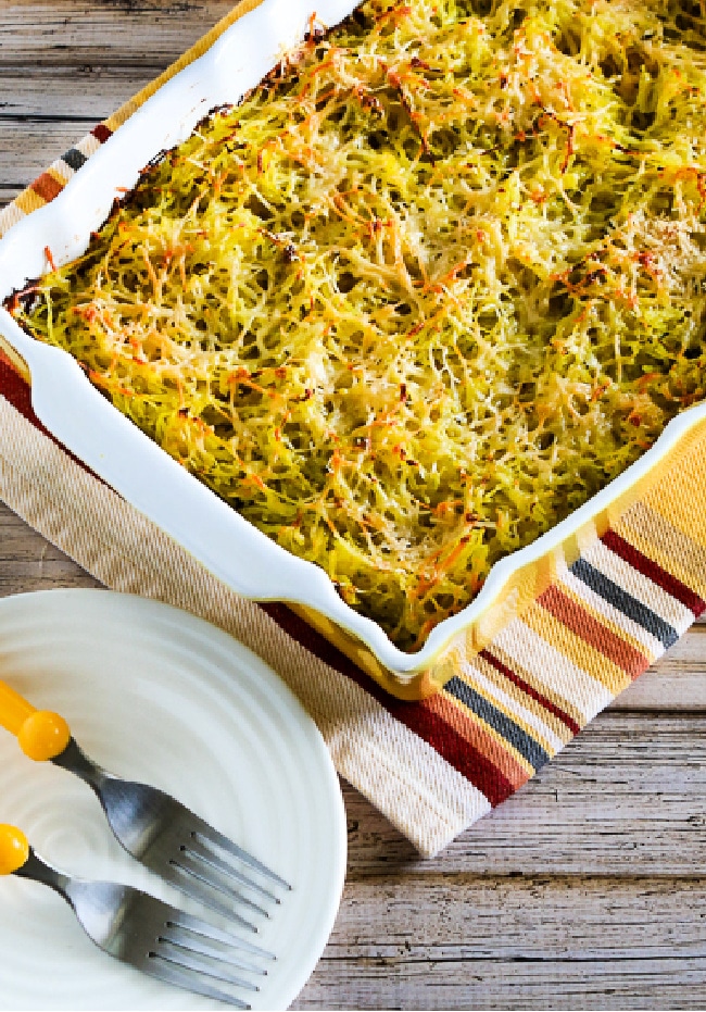 Twice-Baked Spaghetti Squash with Pesto in baking sheet with plates and forks