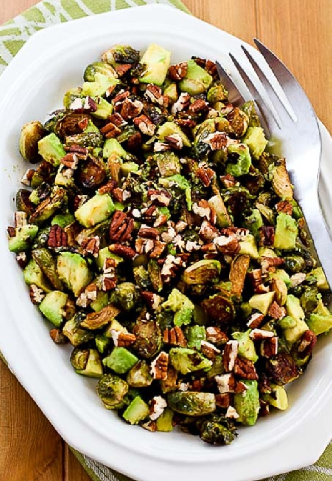 Roasted Brussels Sprouts with Avocados and Pecans close-up on serving plate