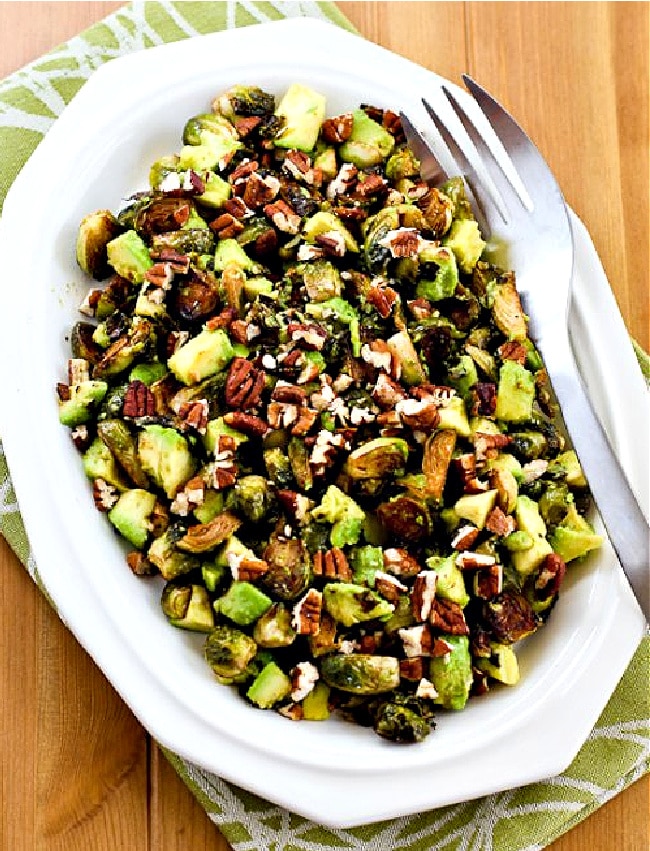 Roasted Brussels Sprouts with Avocados and Pecans finished dish on serving plate