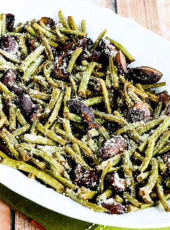 Square image of Roasted Green Beans with Mushrooms, Balsamic, and Parmesan shown on serving platter.