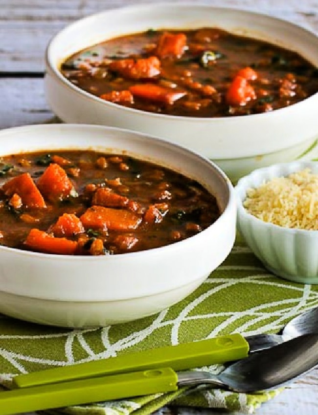 Butternut Squash Kale Soup cropped image showing soup in two bowls with spoons.