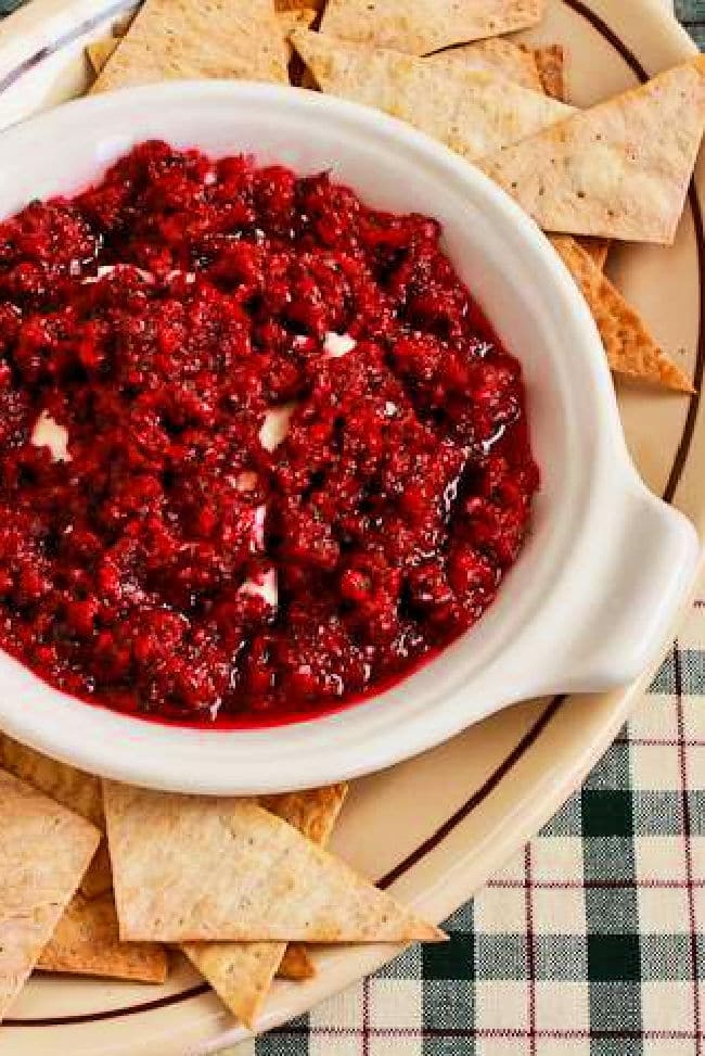 Cranberry Cream Cheese Dip shown on serving plate with chips.