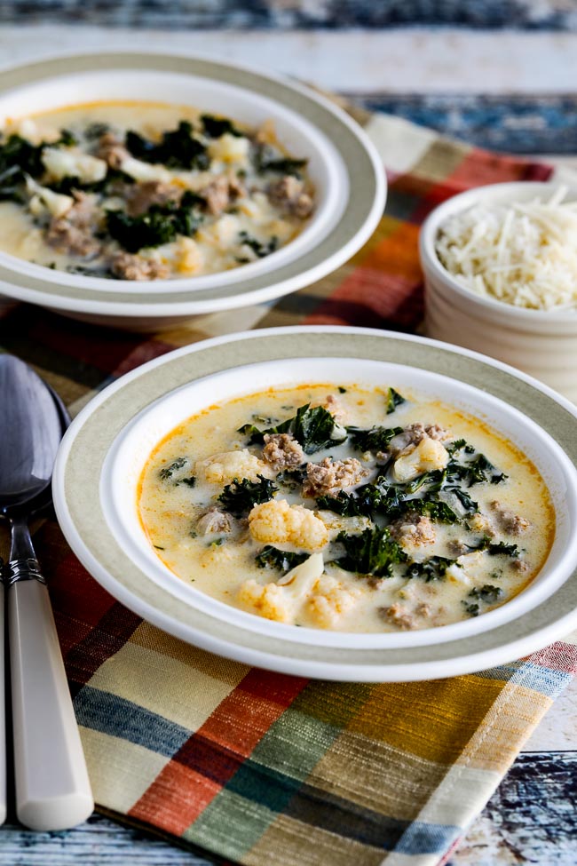Instant Pot Zuppa Toscana Soup in two bowls with Parmesan cheese