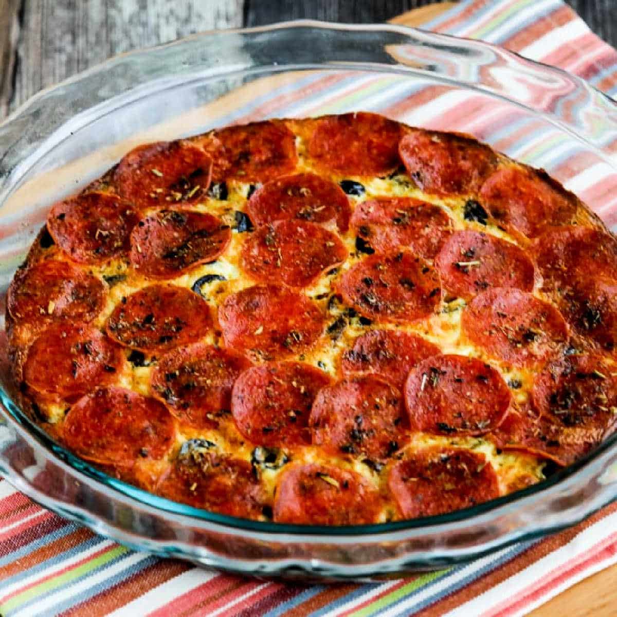 Pepperoni Pizza Keto Crustless Quiche shown in baking dish on napkin.