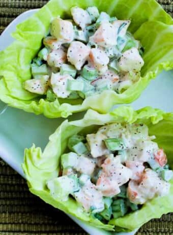 Shrimp Salad Wraps with two wraps shown in cabbage leaves.