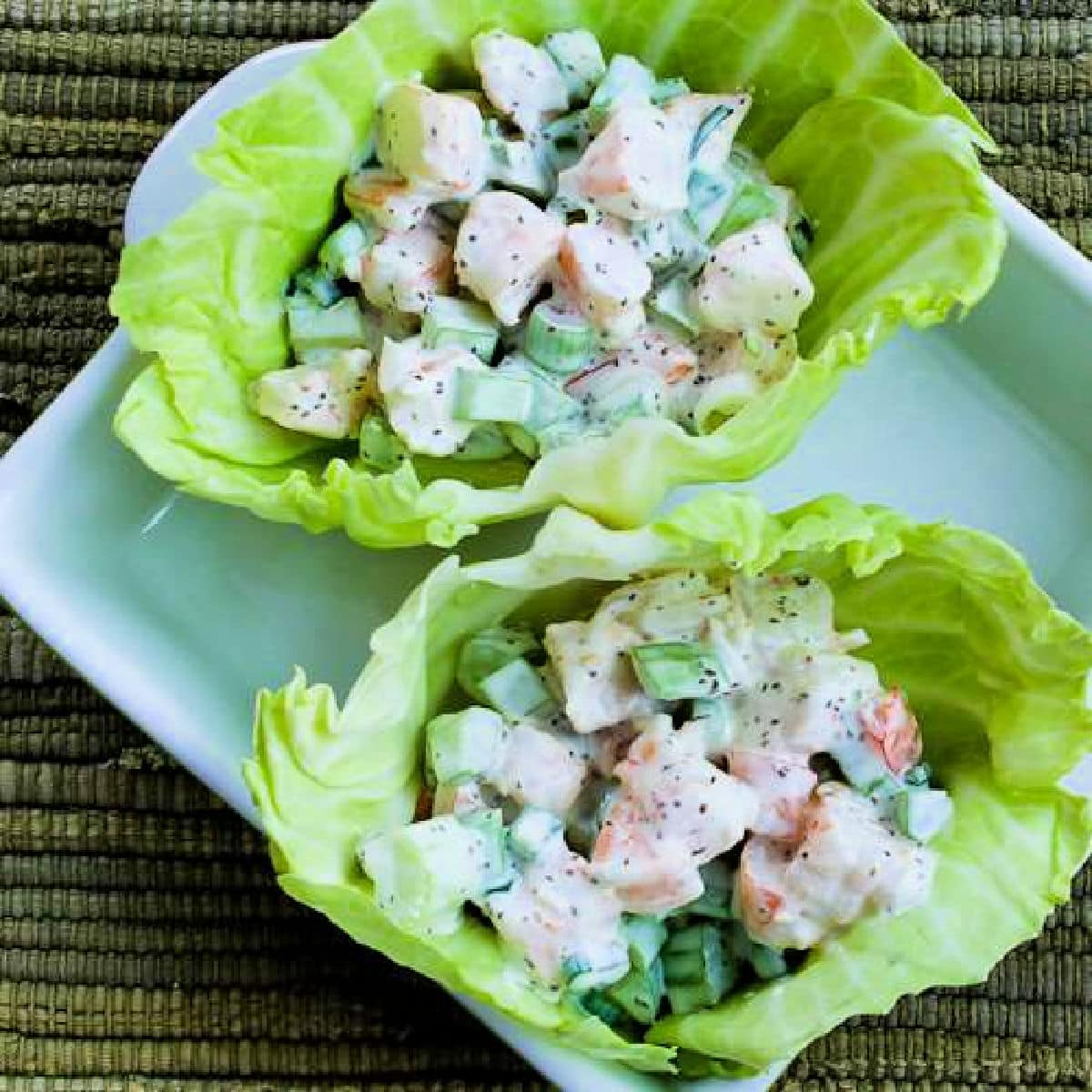 Shrimp Salad Wraps with two wraps shown in cabbage leaves.