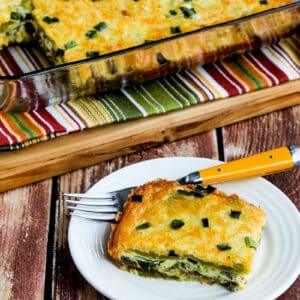 Green Chile Breakfast Casserole with one serving on plate and baking dish in back.