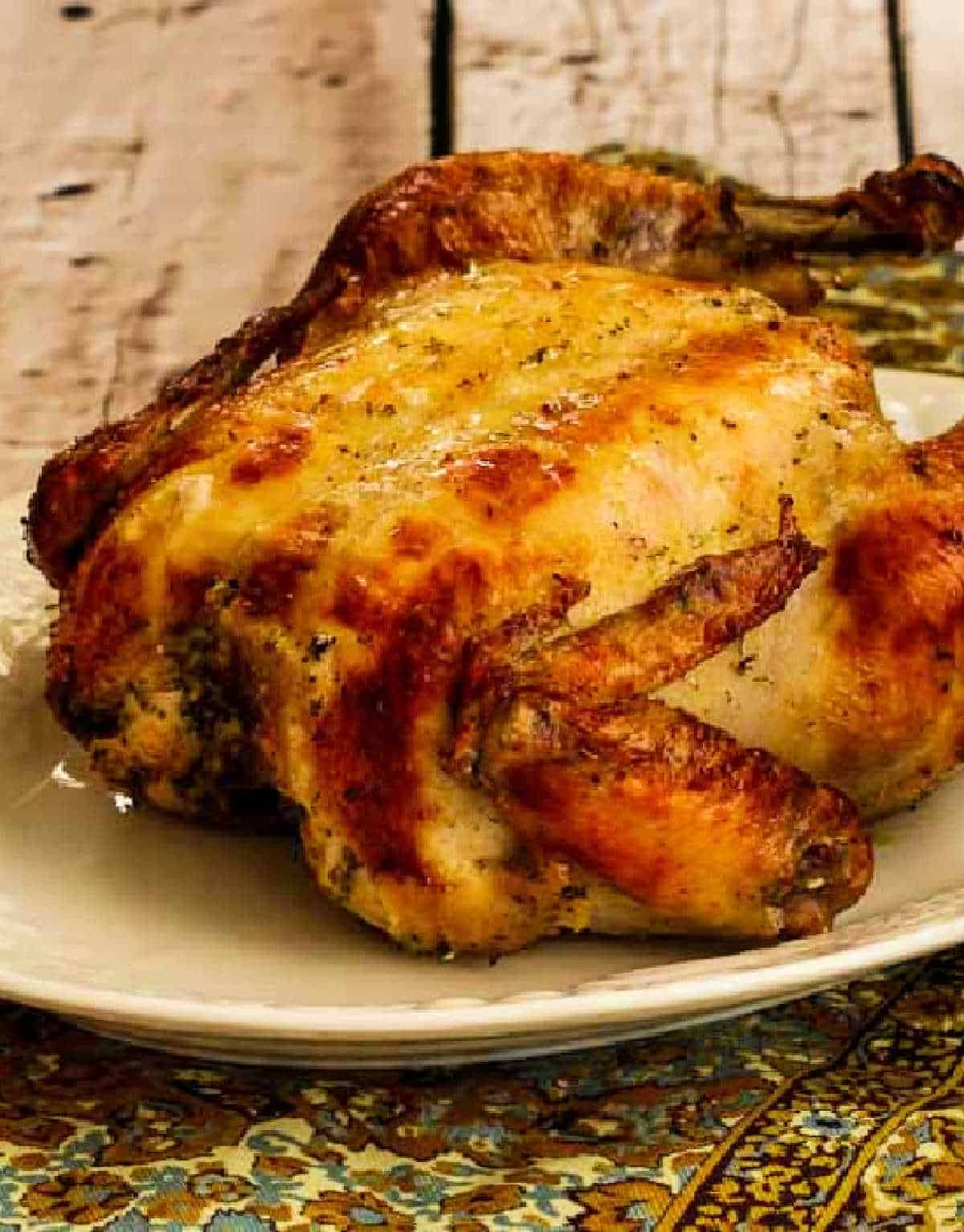 Greek Lemon Chicken, whole chicken on platter on napkin