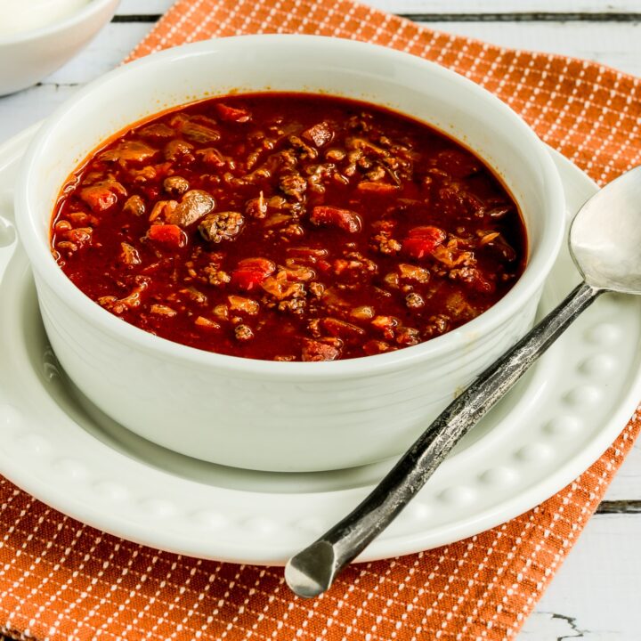 Goulash Soup in serving bowl with sour cream in background