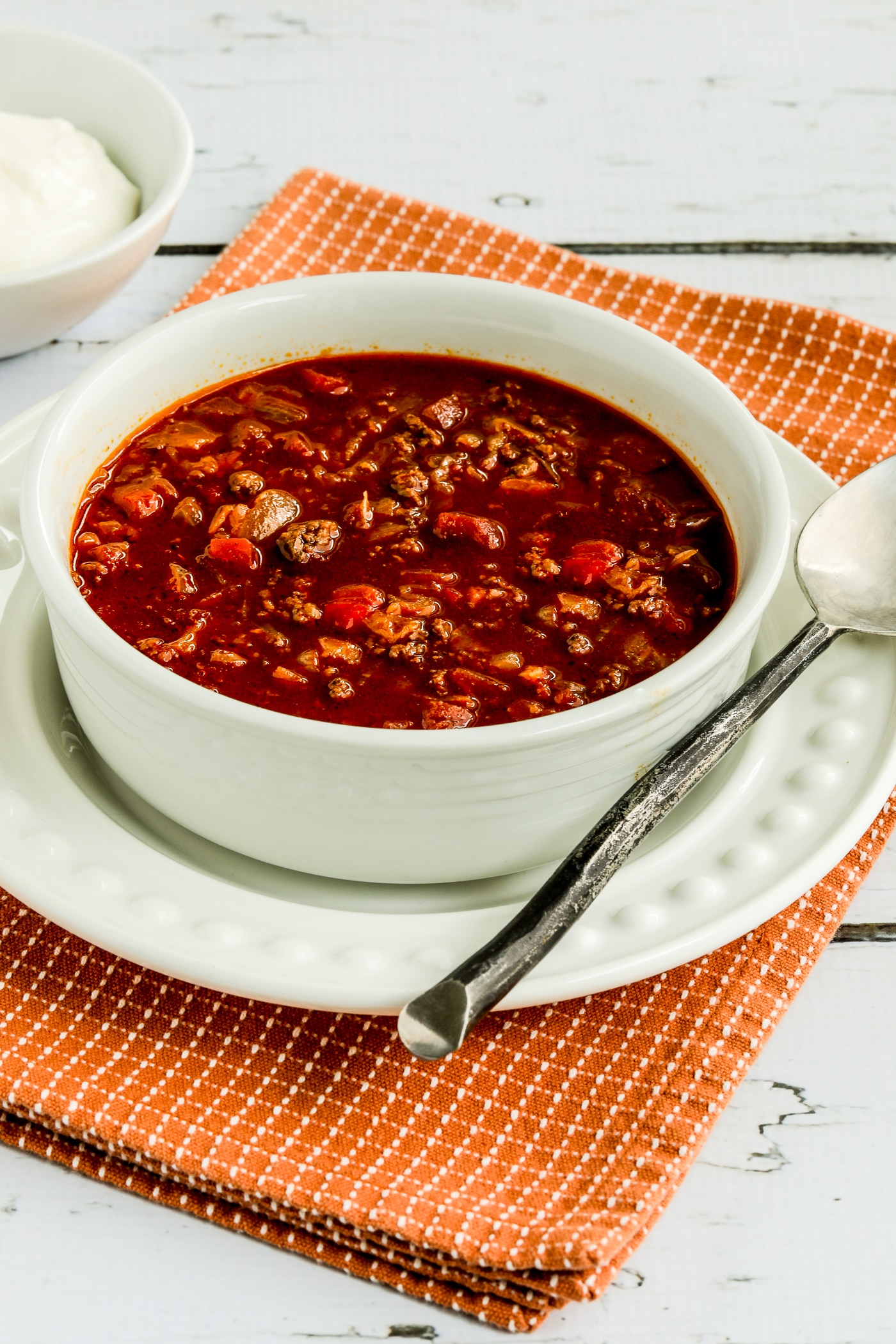 Goulash Soup in serving bowl with sour cream in background