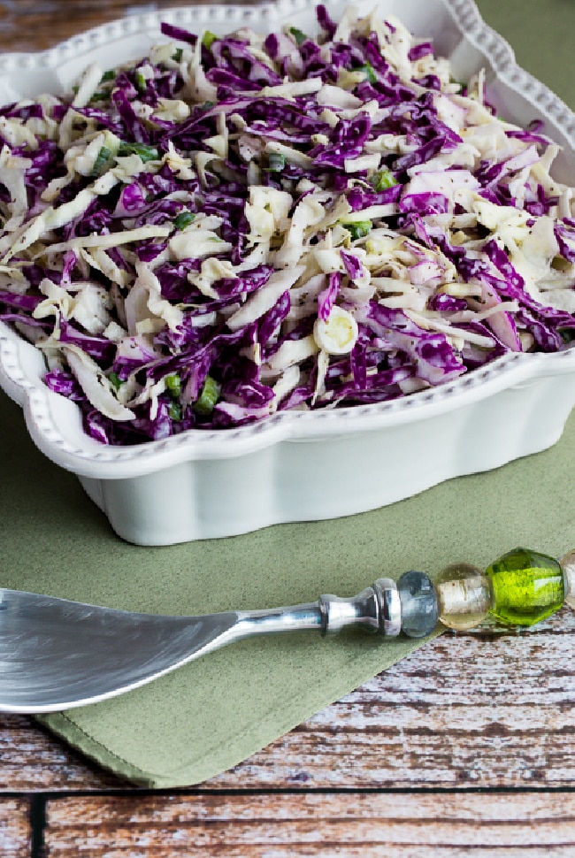 Blue Cheese Coleslaw in serving bowl with fork and green napkin