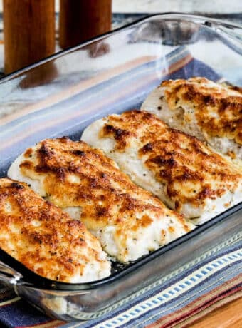 Baked Mayo Parmesan Fish shown with four pieces of fish in baking dish.