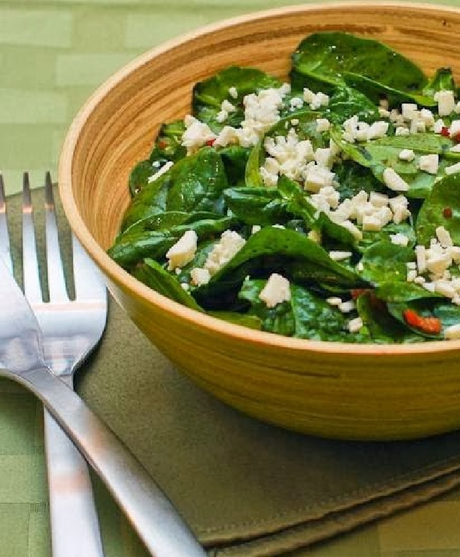 Spinach Salad with Bacon and Feta shown in serving bowl with forks